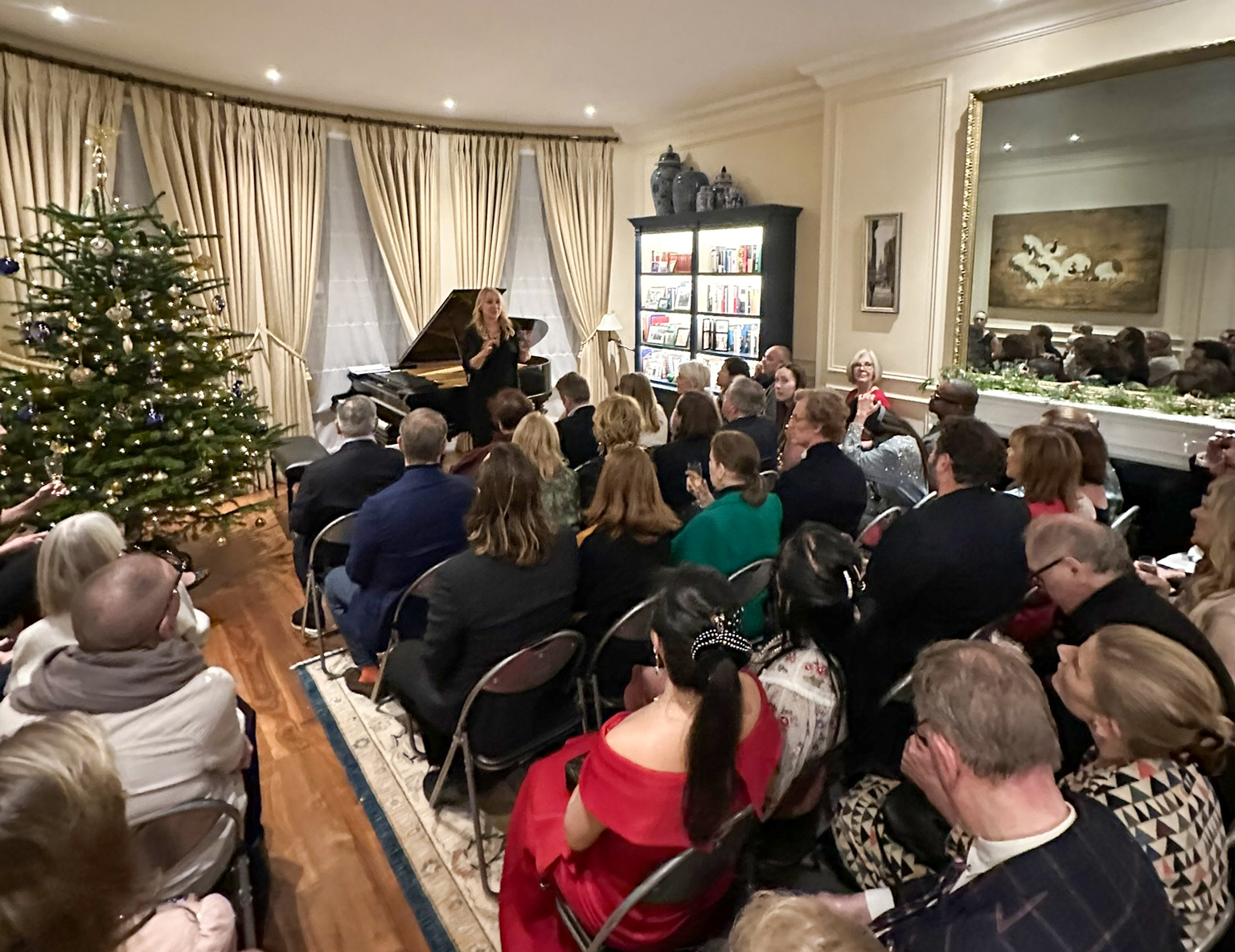 Host welcoming guests into a warmly lit space